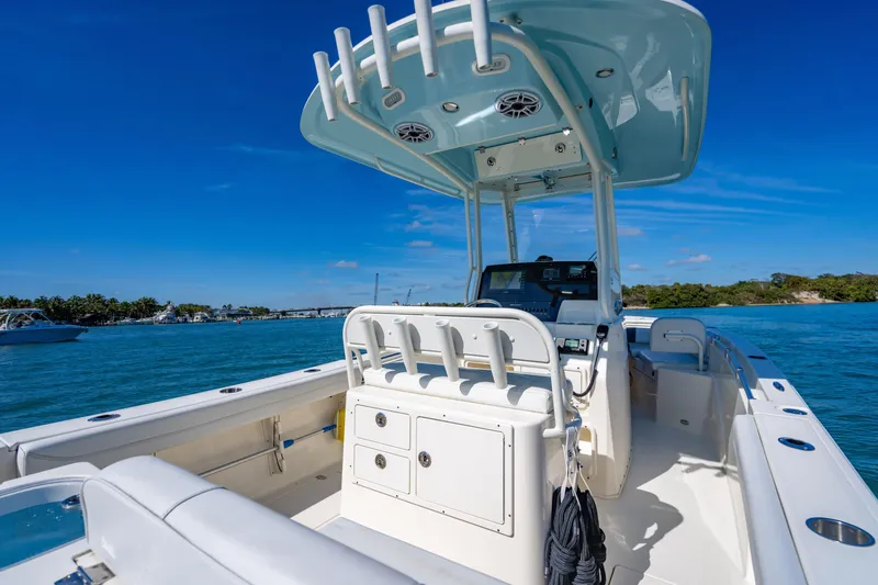 Slide: The Image of 2022 Cobia 240 CC boat interior with helm, ocean view, and clear blue sky. - 19
