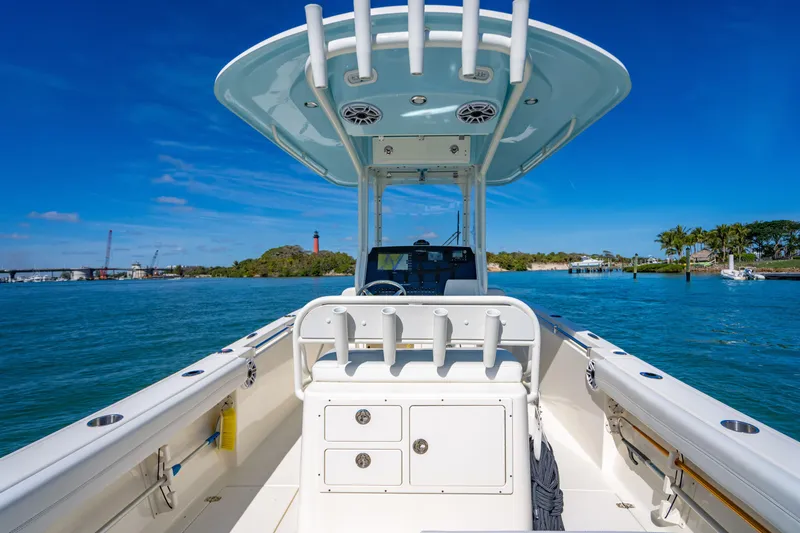 Slide: The Image of 2022 Cobia 240 CC boat on clear blue water, sunny day, scenic background. - 23