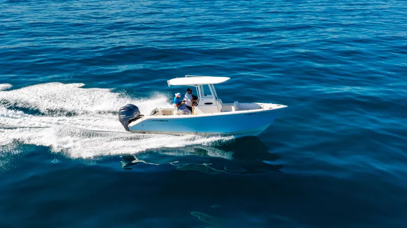 Slide: The Image of 2022 Cobia 240 CC boat cruising on open blue water. - 39