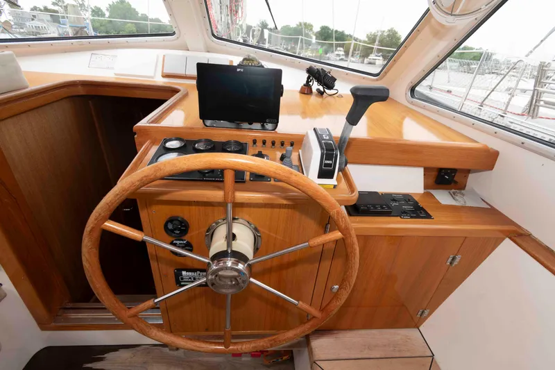 Slide: The Image of Wooden helm station of 2006 Vilm 117 yacht with navigation controls. - 11