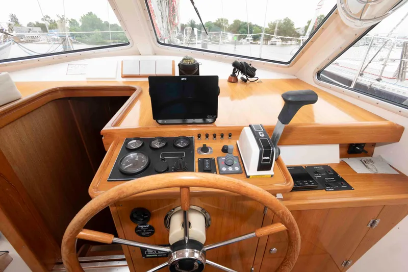 Slide: The Image of Steering wheel and control panel of 2006 Vilm 117 yacht cockpit. - 12