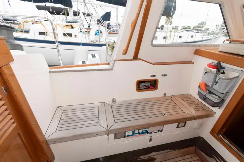 Slide: The Image of Interior of 2006 Vilm 117 yacht with wooden seating and storage compartments. - 14