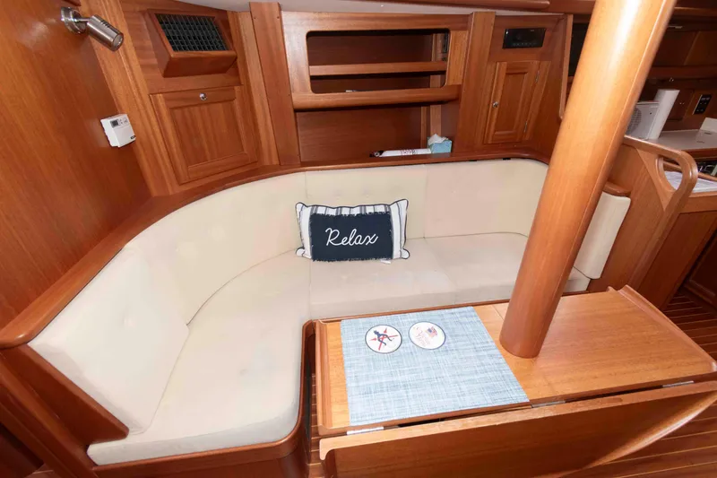Slide: The Image of Cozy Vilm 117 yacht interior with cushioned seating and "Relax" pillow, 2006 model. - 17