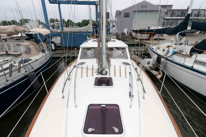 Slide: The Image of Sailboat Vilm 117, 2006 model, docked at marina with other boats. - 2