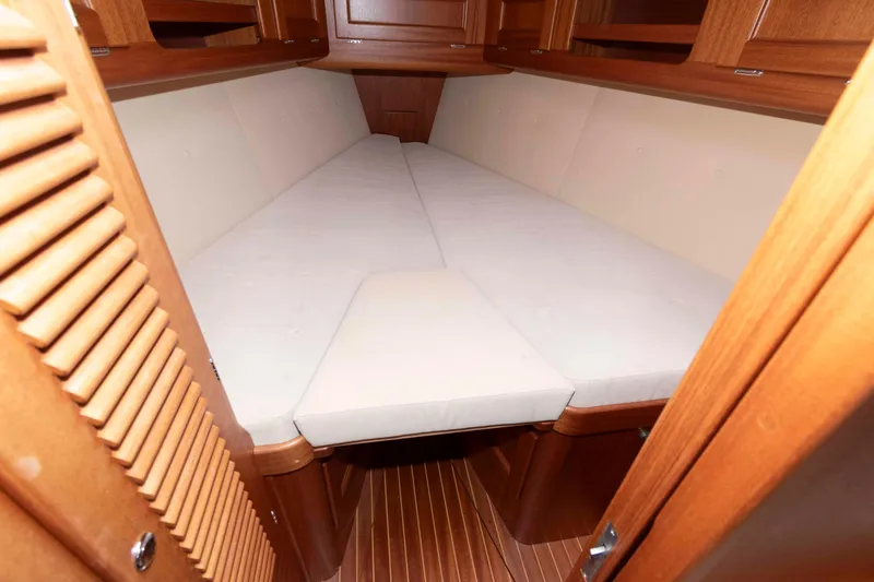 Slide: The Image of Cozy cabin interior of 2006 Vilm 117 yacht with wooden finish and cushioned bed. - 21