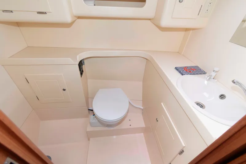 Slide: The Image of Compact bathroom in 2006 Vilm 117 yacht with toilet, sink, and storage cabinets. - 23