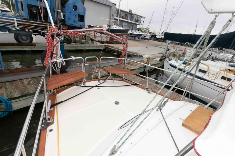 Slide: The Image of Sailboat Vilm 117, 2006 model, docked at marina with wooden deck and rigging. - 5