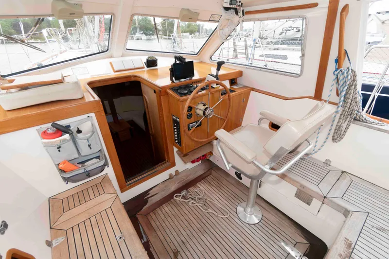 Slide: The Image of Interior of 2006 Vilm 117 sailboat cockpit with steering wheel and navigation equipment. - 9