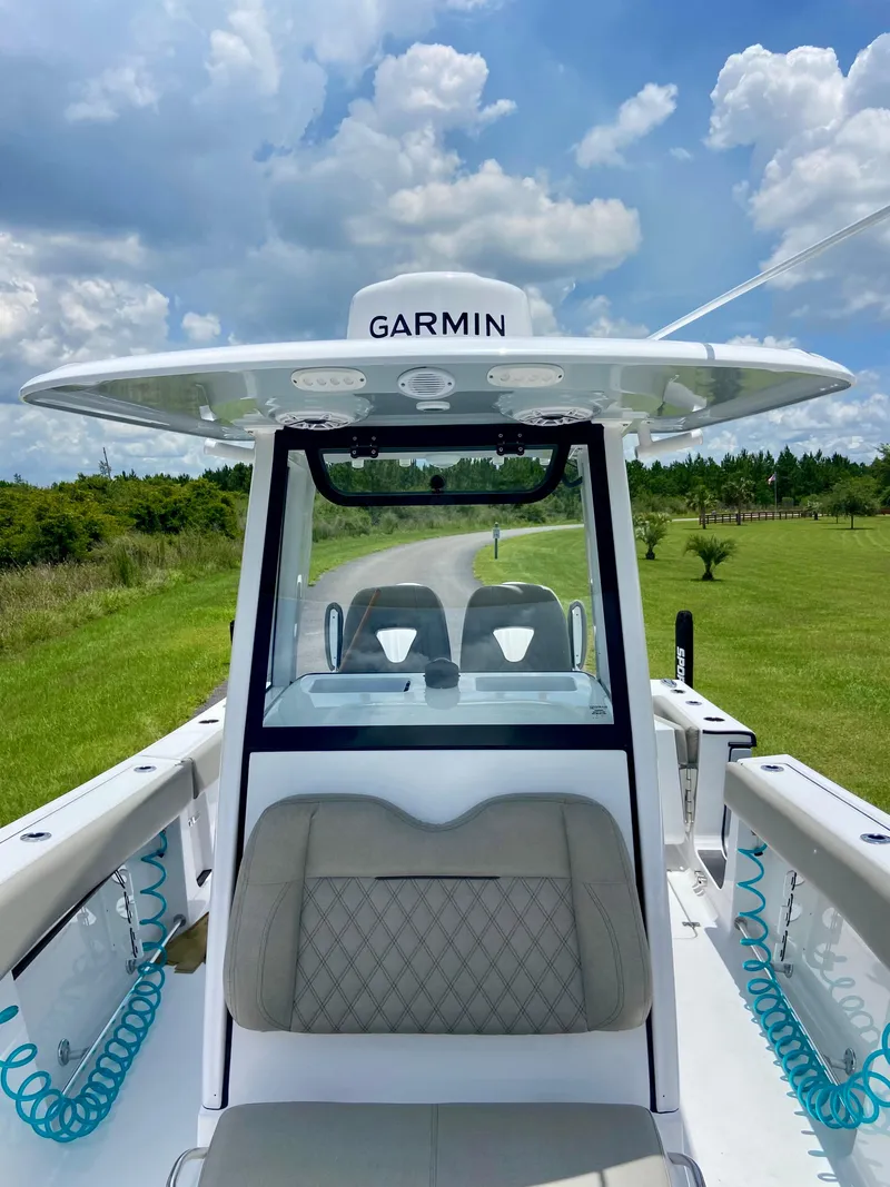 Slide: The Image of 2025 Sportsman Open 262 Center Console boat with Garmin equipment, set against a scenic backdrop. - 10