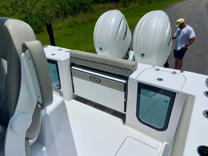 Slide: The Image of 2025 Sportsman Open 262 Center Console boat with dual engines, viewed from the deck. - 12