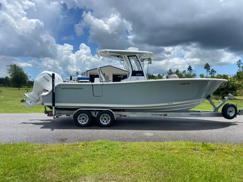 Slide: The Image of 2025 Sportsman Open 262 Center Console boat on trailer under cloudy sky. - 4
