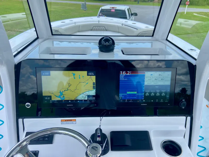 Slide: The Image of 2025 Sportsman Open 262 Center Console dashboard with navigation screens and steering wheel. - 7