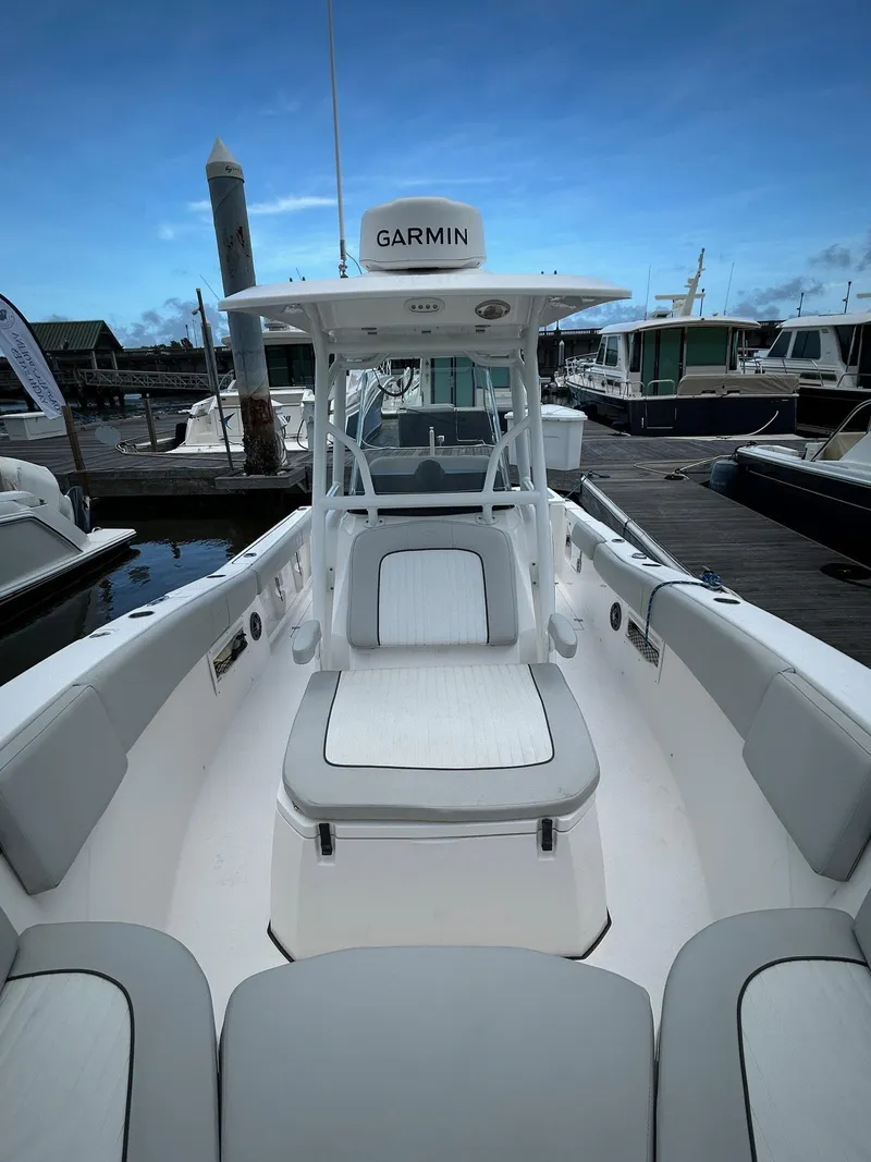 Slide: The Image of 2022 Sea Fox 268 Commander boat docked, featuring Garmin equipment and spacious seating. - 10