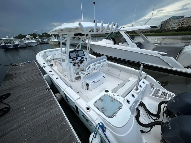 Slide: The Image of 2022 Sea Fox 268 Commander boat docked at marina, featuring dual engines and modern controls. - 12
