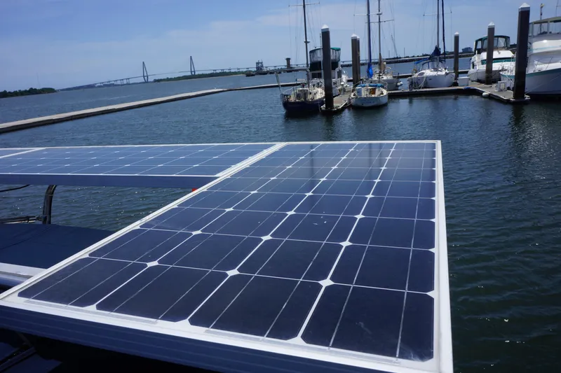 Slide: The Image of Solar panels on a 1993 Hunter 35.5 yacht docked at a marina. - 11