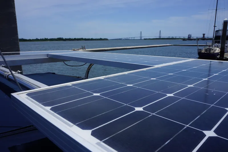 Slide: The Image of Solar panels on a 1993 Hunter 35.5 sailboat with a scenic waterfront view. - 12
