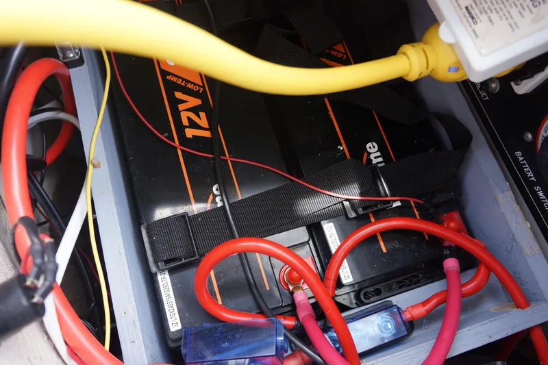 Slide: The Image of 12V battery setup with cables in a 1993 Hunter 35.5 model. - 13
