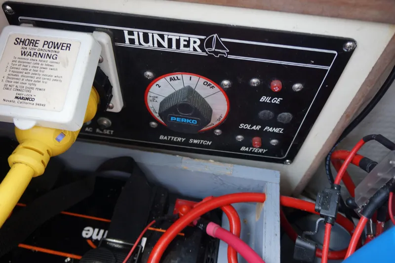 Slide: The Image of Control panel of a 1993 Hunter 35.5 boat with battery switch and shore power connection. - 14