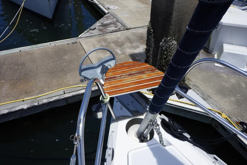 Slide: The Image of Sailboat bow with wooden platform, docked at marina. Hunter 35.5, 1993 model. - 18