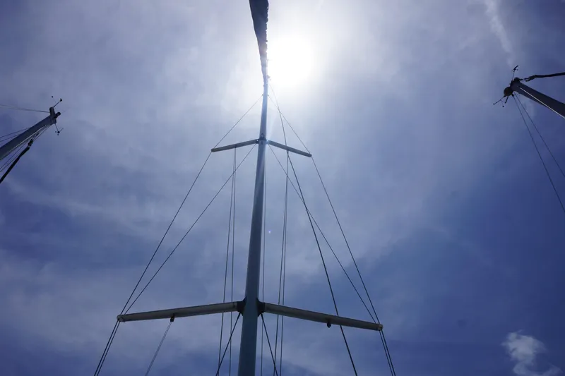 Slide: The Image of Sailboat mast against bright sun and blue sky, Hunter 35.5, 1993 model. - 19