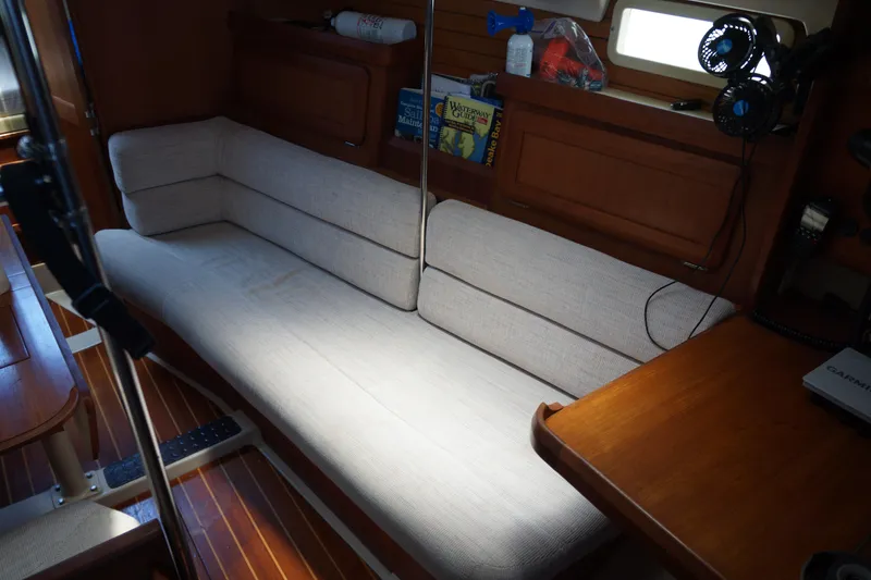 Slide: The Image of Interior of 1993 Hunter 35.5 sailboat with cushioned seating and wooden accents. - 23