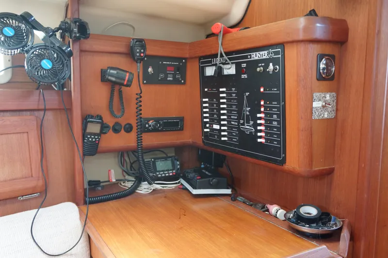 Slide: The Image of Navigation station of a 1993 Hunter 35.5 sailboat with communication equipment and control panel. - 24