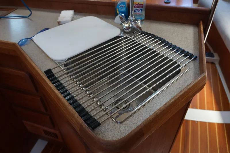 Slide: The Image of 1993 Hunter 35.5 yacht kitchen sink with drying rack and cutting board. - 28