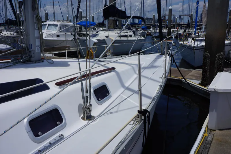 Slide: The Image of Sailboat docked in marina, Hunter 35.5 model, 1993, surrounded by other boats. - 3