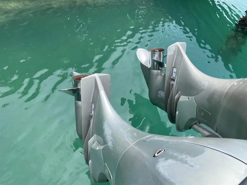 Slide: The Image of Twin outboard motors on a 2006 Everglades 260 CC in clear water. - 13