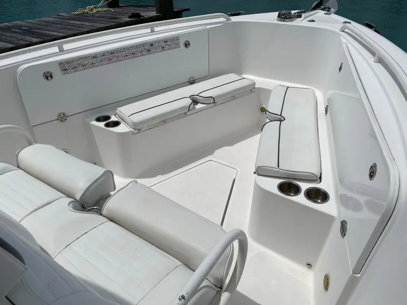 Slide: The Image of 2006 Everglades 260 CC boat interior with white seating and cup holders. - 7