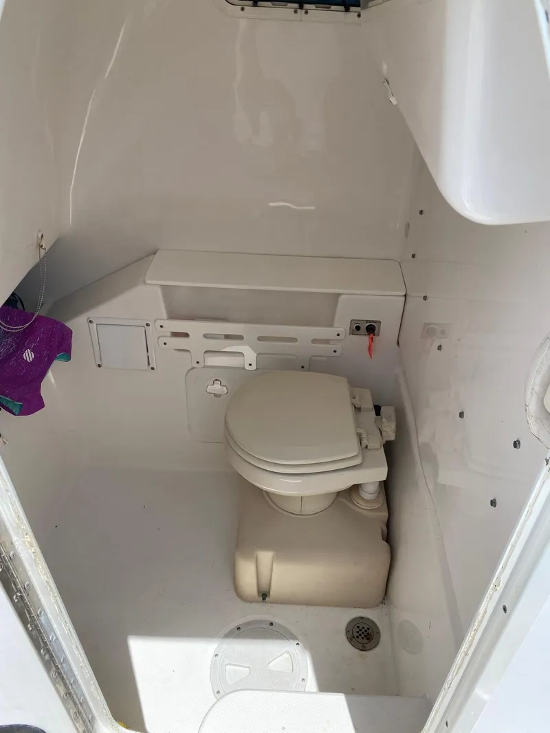 Slide: The Image of 2006 Everglades 260 CC boat interior with compact marine toilet. - 9