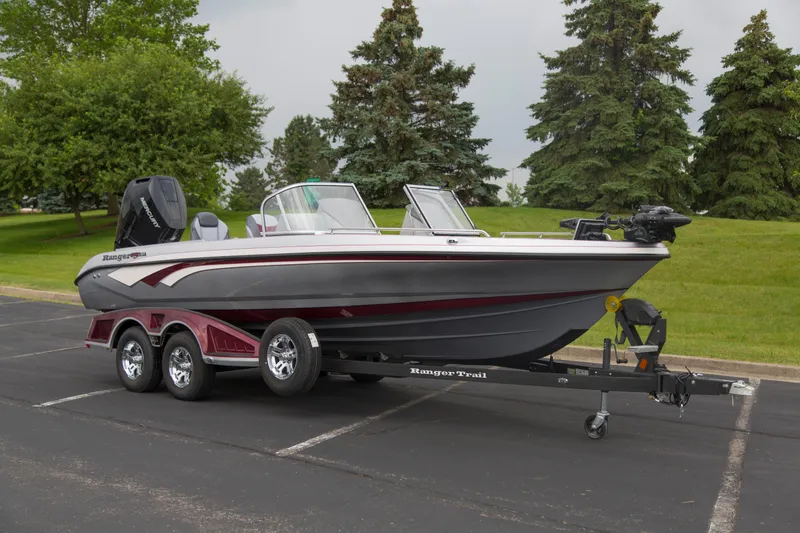 The Image of 2025 Ranger 621FS Pro boat on trailer, parked outdoors with trees in background. - 0