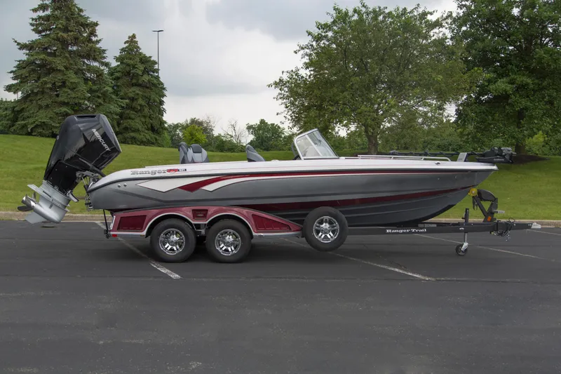 Slide: The Image of 2025 Ranger 621FS Pro boat on trailer, parked outdoors with trees in background. - 1