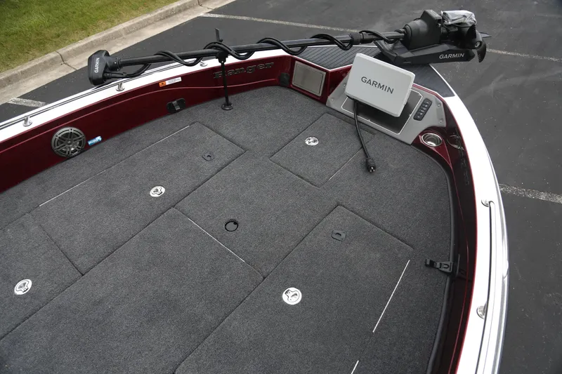 Slide: The Image of 2025 Ranger 621FS Pro boat deck with Garmin electronics and carpeted storage compartments. - 2