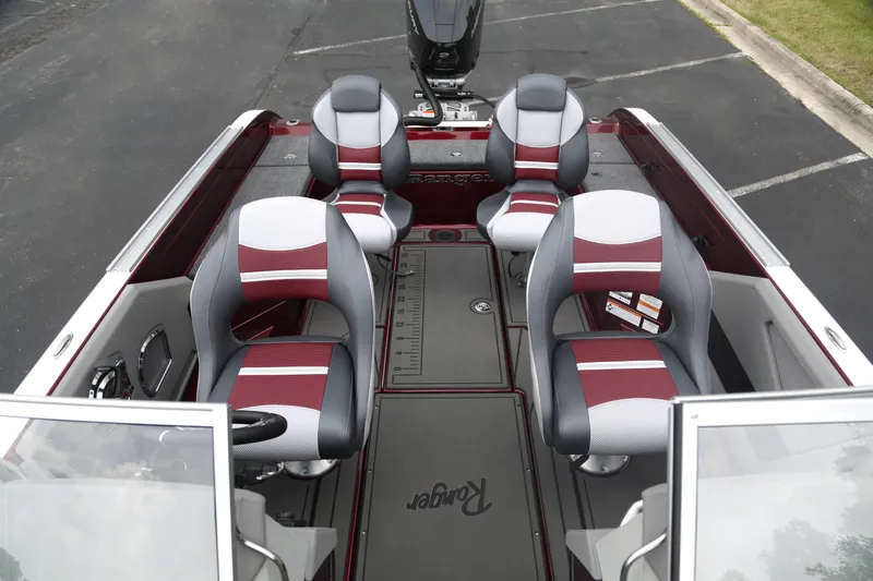 Slide: The Image of 2025 Ranger 621FS Pro boat interior with four seats and measuring ruler on deck. - 3