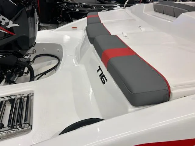 Slide: The Image of 2025 Tahoe T16 boat interior with gray and red seating, featuring a Mercury engine. - 3