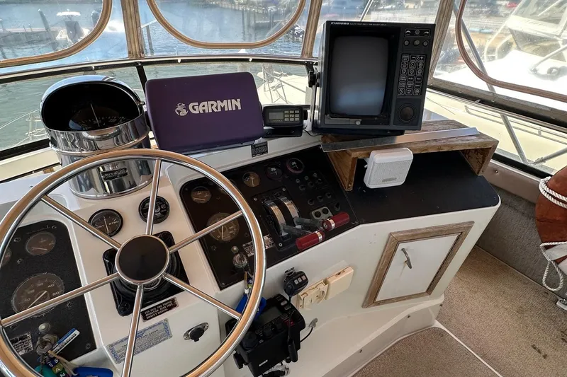 Slide: The Image of 1988 Carver 38 Aft Cabin helm with Garmin navigation and vintage controls. - 10