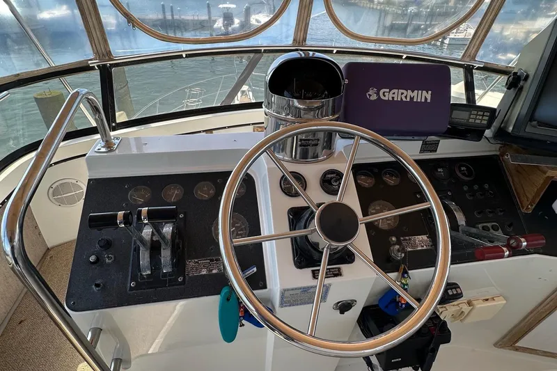 Slide: The Image of 1988 Carver 38 Aft Cabin helm with Garmin navigation system and steering wheel. - 11