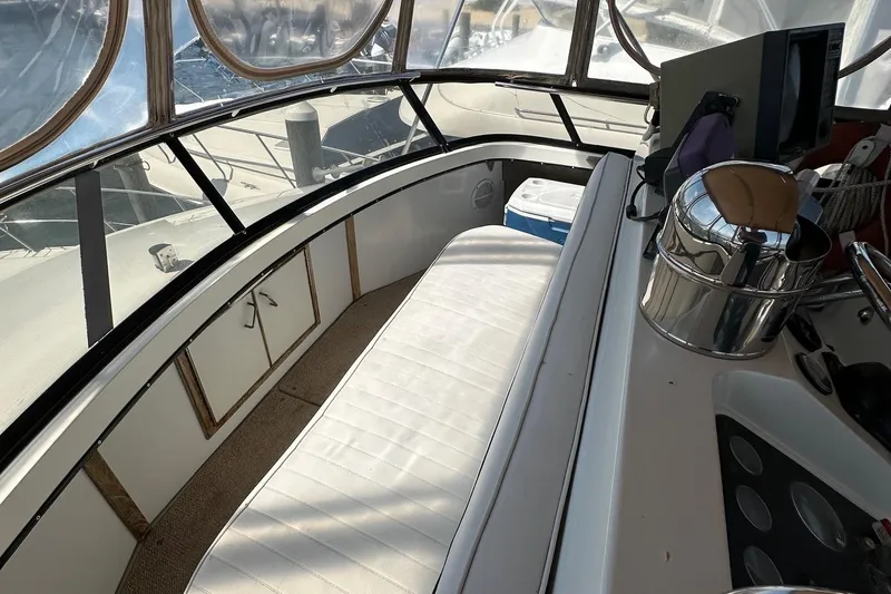 Slide: The Image of 1988 Carver 38 Aft Cabin interior with seating, helm, and nautical equipment. - 12