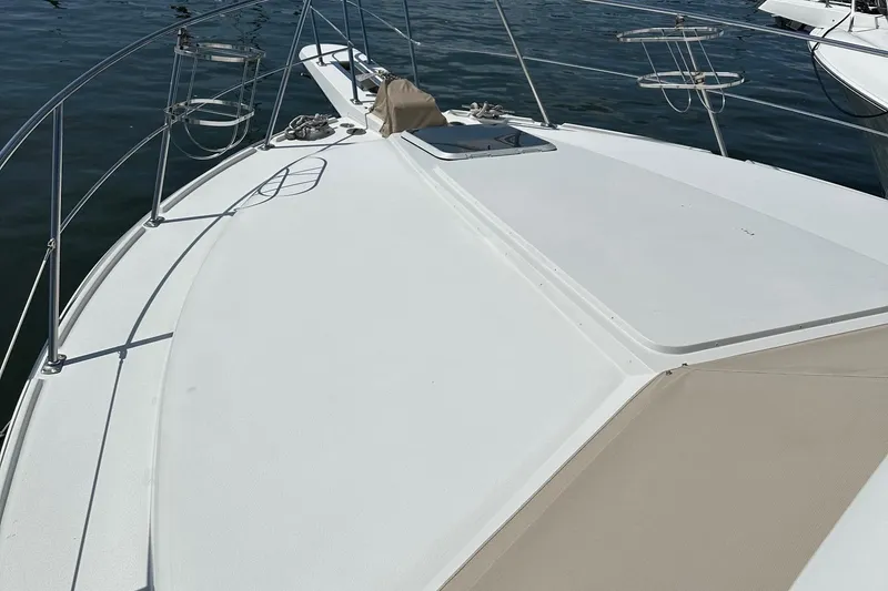Slide: The Image of 1988 Carver 38 Aft Cabin yacht deck with railing, on calm water. - 13