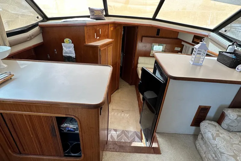 Slide: The Image of Interior of 1988 Carver 38 Aft Cabin yacht with wood accents and seating area. - 16