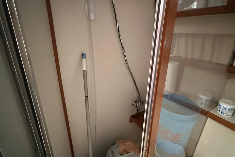 Slide: The Image of Shower area in 1988 Carver 38 Aft Cabin with cleaning supplies and storage shelves. - 20