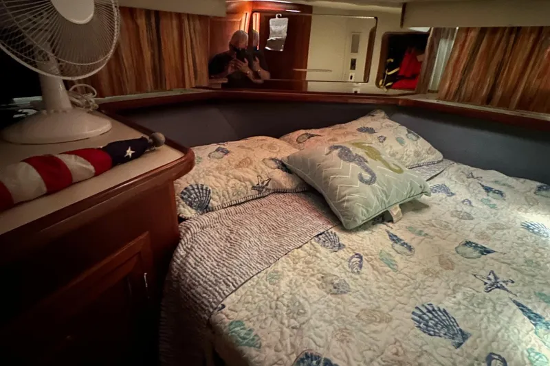 Slide: The Image of Cozy 1988 Carver 38 Aft Cabin bedroom with nautical-themed bedding and decor. - 23