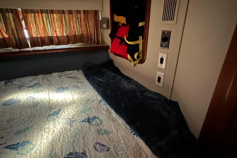 Slide: The Image of Cozy cabin interior of 1988 Carver 38 Aft Cabin with nautical-themed bedding. - 24