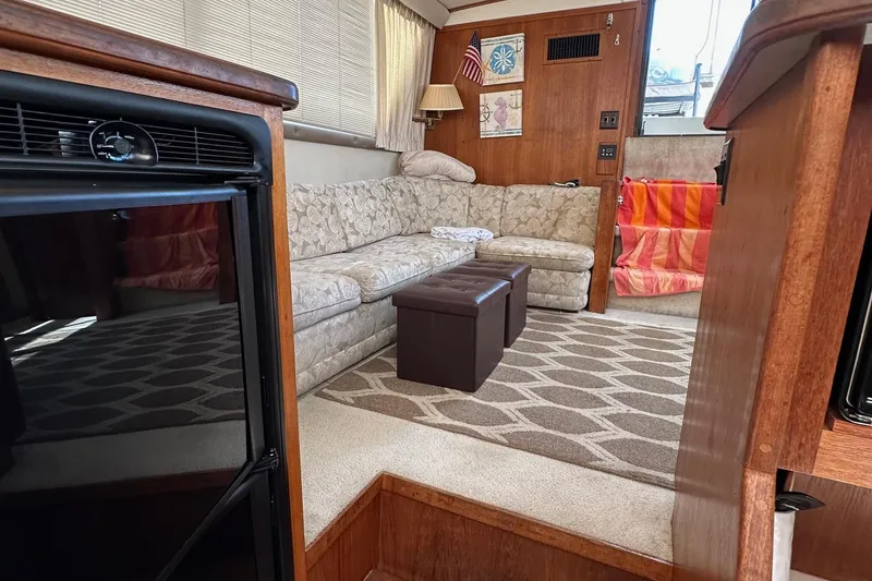 Slide: The Image of Interior of 1988 Carver 38 Aft Cabin with cozy seating and decor. - 25