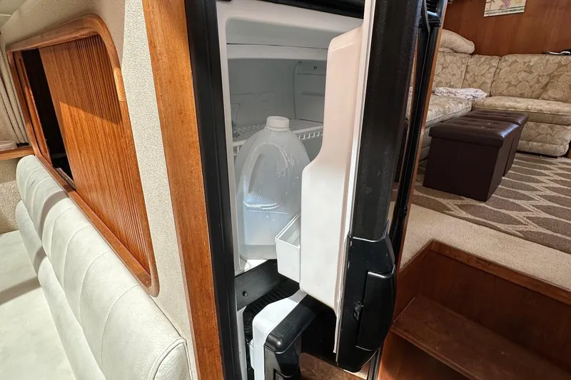 Slide: The Image of Open fridge in 1988 Carver 38 Aft Cabin, showing interior with water jug. - 26