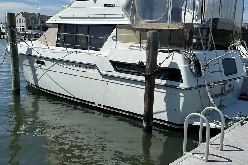 Slide: The Image of 1988 Carver 38 Aft Cabin yacht docked at marina, side view. - 3