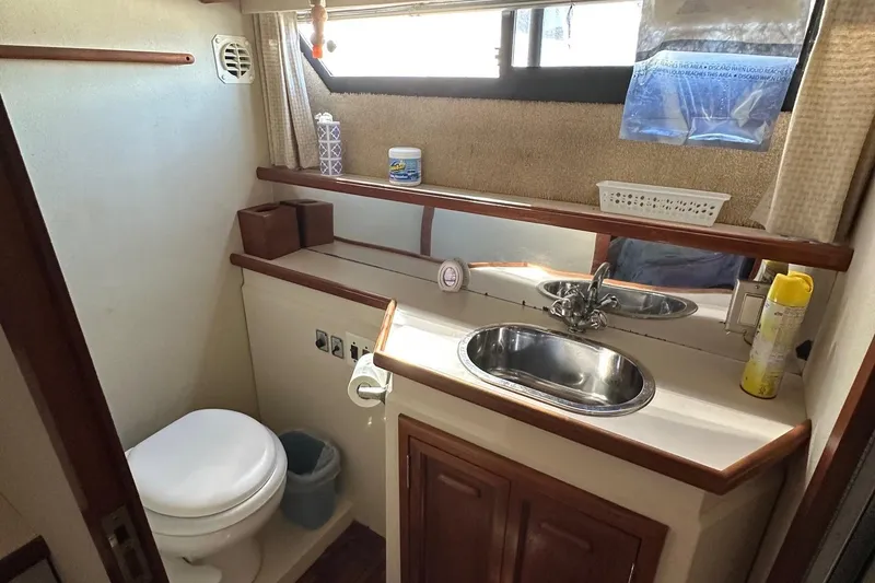Slide: The Image of 1988 Carver 38 Aft Cabin bathroom with sink, toilet, and storage. - 30