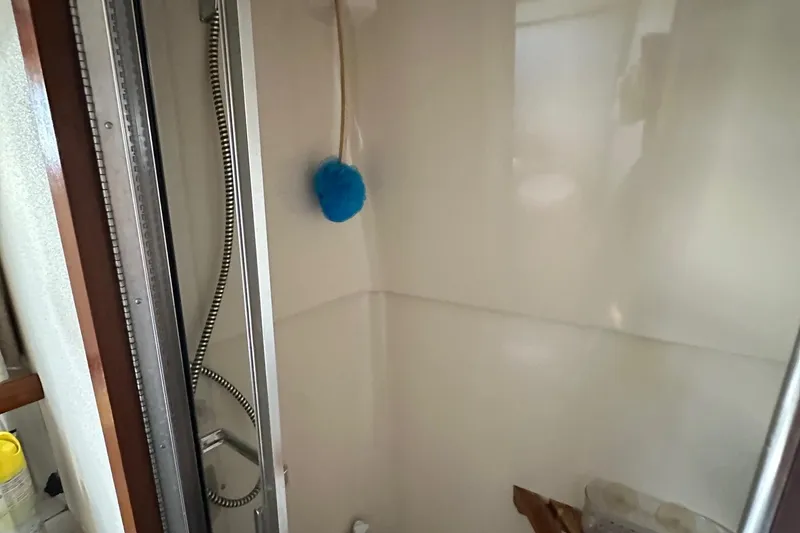 Slide: The Image of Shower area in 1988 Carver 38 Aft Cabin yacht with blue sponge and handheld showerhead. - 31