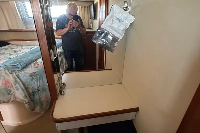 Slide: The Image of 1988 Carver 38 Aft Cabin interior with vanity and bed, person taking photo. - 33